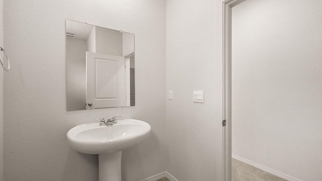bathroom with baseboards and a sink