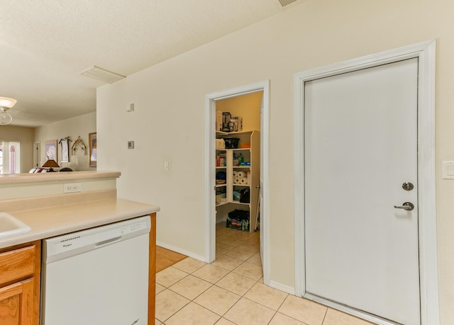 4449 Sunflower Ct SE, Rio Rancho, NM 87124 - kitchen featuring dishwasher, light tile patterned flooring, light countertops, baseboards, and a sink