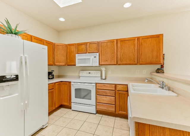 4449 Sunflower Ct SE, Rio Rancho, NM 87124 - kitchen with white appliances, a sink, brown cabinets, a skylight, and light countertops