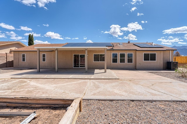 2028 Clearwater Loop NE, Rio Rancho, NM 87144 - rear view of house with a patio area, roof mounted solar panels, and stucco siding