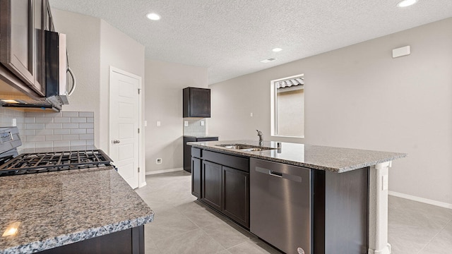 kitchen featuring stainless steel dishwasher, a sink, backsplash, light stone countertops, and gas stove