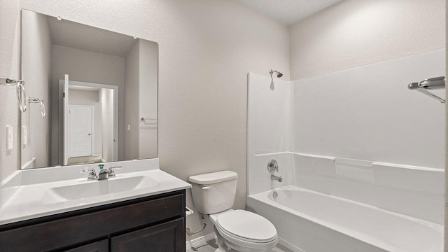 bathroom featuring shower / bath combination, a textured wall, toilet, and vanity