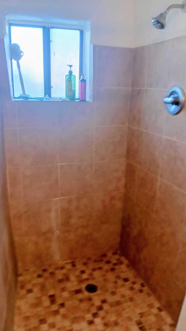 bathroom with a tile shower