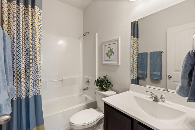 bathroom with a textured wall, shower / tub combo with curtain, vanity, and toilet