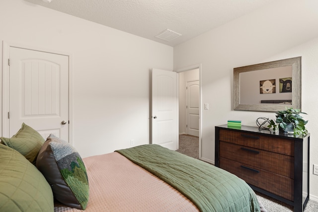 carpeted bedroom featuring visible vents and baseboards