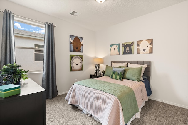 carpeted bedroom featuring baseboards and visible vents