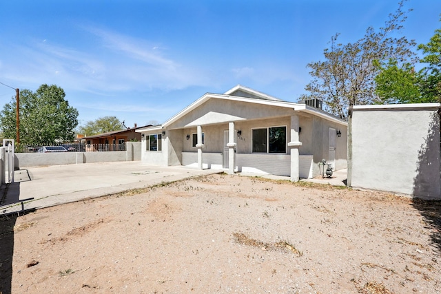 bungalow with fence and stucco siding