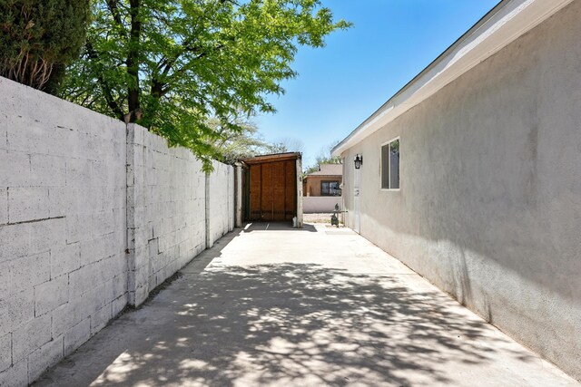 view of home's exterior with fence, a patio area, and stucco siding