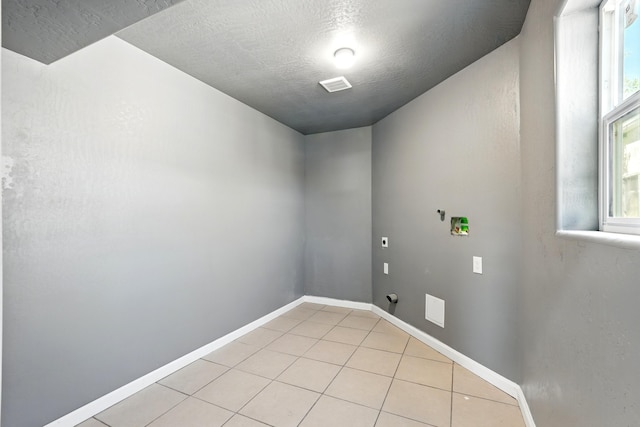laundry area with baseboards, visible vents, laundry area, and light tile patterned floors