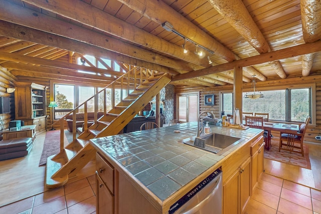 387 County Rd B64, Pecos, NM 87552 - kitchen featuring tile countertops, a sink, dishwasher, log walls, and wooden ceiling
