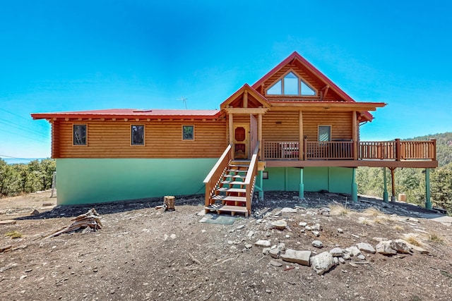 387 County Rd B64, Pecos, NM 87552 - cabin featuring a wooden deck, metal roof, stairs, and faux log siding