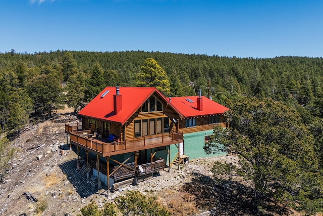 387 County Rd B64, Pecos, NM 87552 - back of house with a wooded view, log siding, a chimney, and a wooden deck