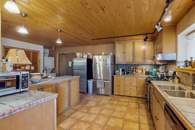 387 County Rd B64, Pecos, NM 87552 - kitchen with stacked washer and clothes dryer, stainless steel appliances, tile countertops, a sink, and wooden ceiling