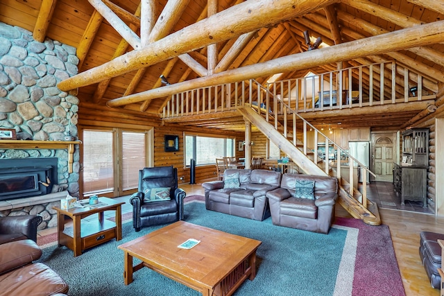 387 County Rd B64, Pecos, NM 87552 - living area featuring log walls, wood ceiling, stairs, wood finished floors, and high vaulted ceiling