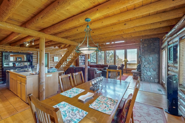 387 County Rd B64, Pecos, NM 87552 - dining area featuring rustic walls, beam ceiling, wooden ceiling, and light wood-style flooring