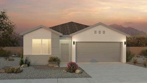 single story home featuring a garage, driveway, and stucco siding