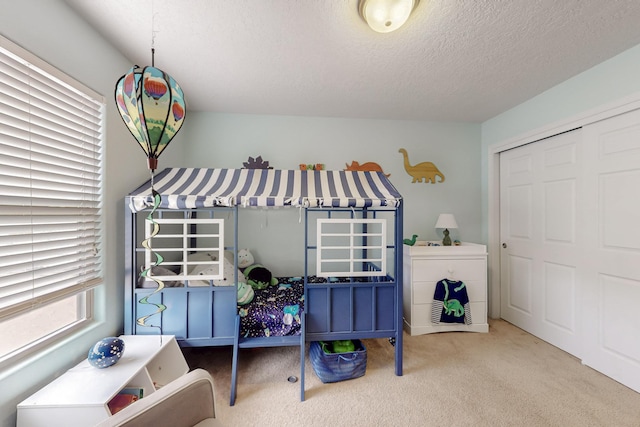 7105 Napoleon Rd NE, Rio Rancho, NM 87144 - carpeted bedroom featuring a textured ceiling and a closet