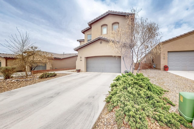7105 Napoleon Rd NE, Rio Rancho, NM 87144 - mediterranean / spanish-style house featuring a tile roof, stucco siding, concrete driveway, and an attached garage