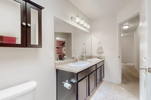 7105 Napoleon Rd NE, Rio Rancho, NM 87144 - full bathroom with toilet, tile patterned flooring, double vanity, and baseboards