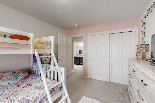7105 Napoleon Rd NE, Rio Rancho, NM 87144 - bedroom with light colored carpet, a closet, and a textured ceiling