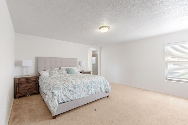 7105 Napoleon Rd NE, Rio Rancho, NM 87144 - bedroom with arched walkways, carpet floors, and a textured ceiling