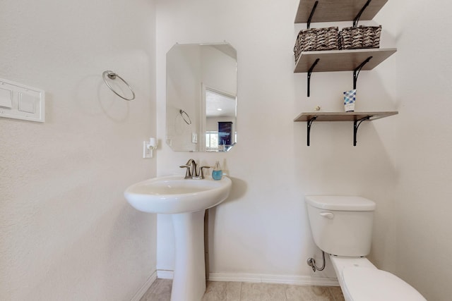 7105 Napoleon Rd NE, Rio Rancho, NM 87144 - half bath with baseboards, toilet, and a sink