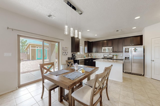 7105 Napoleon Rd NE, Rio Rancho, NM 87144 - dining space with a textured ceiling, light tile patterned floors, recessed lighting, and baseboards