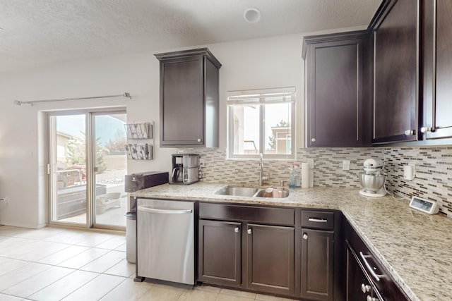 7105 Napoleon Rd NE, Rio Rancho, NM 87144 - kitchen featuring stainless steel dishwasher, a sink, decorative backsplash, dark brown cabinets, and a textured ceiling