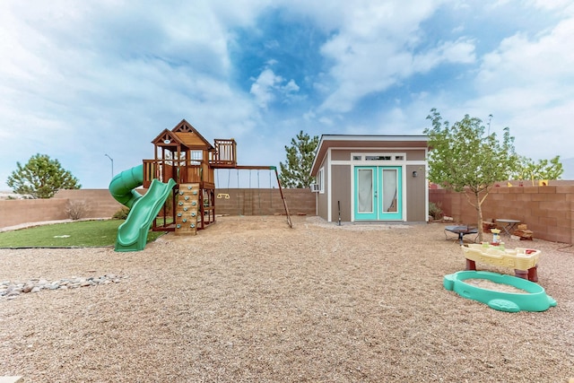 7105 Napoleon Rd NE, Rio Rancho, NM 87144 - view of play area with a fenced backyard and an outdoor structure