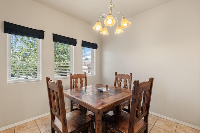 5668 Cold Creek Ave NW, Albuquerque, NM 87114 - dining space with a chandelier, light tile patterned flooring, and baseboards