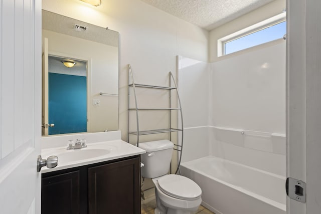 bathroom featuring shower / bathing tub combination, toilet, vanity, visible vents, and a textured ceiling