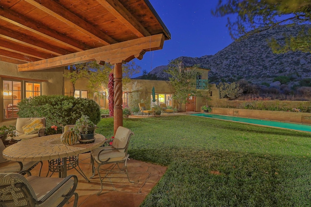 view of yard featuring a patio area and a mountain view