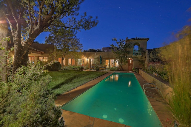 253 Spring Creek Pl NE, Albuquerque, NM 87122 - pool at night with a yard and an outdoor pool