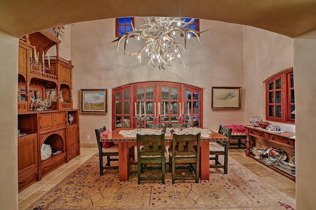 253 Spring Creek Pl NE, Albuquerque, NM 87122 - dining room with a high ceiling, light tile patterned floors, and a chandelier