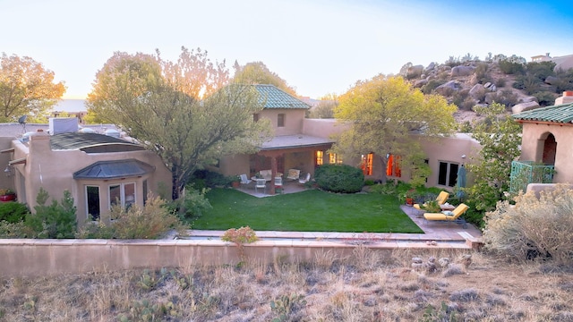 253 Spring Creek Pl NE, Albuquerque, NM 87122 - back of property featuring a yard, stucco siding, a patio, and a tiled roof