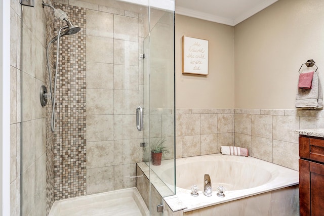 bathroom with a garden tub, a stall shower, crown molding, and vanity
