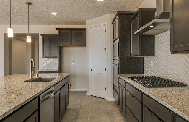 kitchen with a sink, stainless steel appliances, baseboards, backsplash, and wall chimney range hood