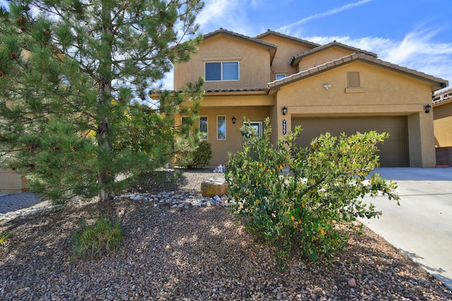 7227 Wasilla Dr NE, Rio Rancho, NM 87144 - view of front of house featuring an attached garage, concrete driveway, a tiled roof, and stucco siding