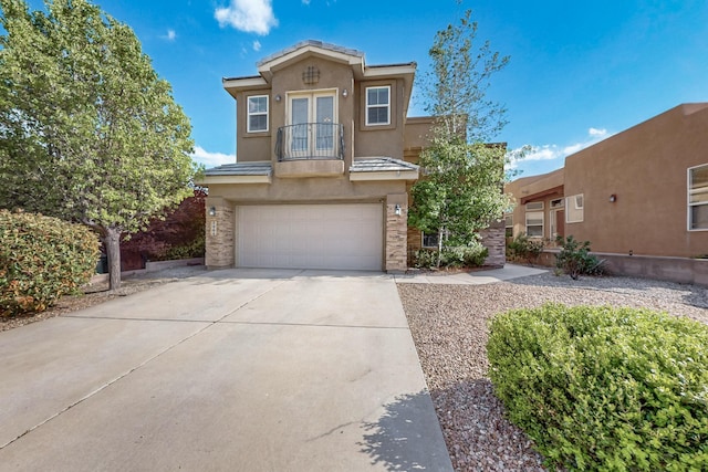3404 Lockerbie Dr SE, Rio Rancho, NM 87124 - view of front of home with concrete driveway, a tiled roof, french doors, a garage, and stucco siding