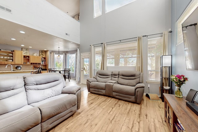 3404 Lockerbie Dr SE, Rio Rancho, NM 87124 - living area with recessed lighting, a high ceiling, visible vents, and light wood-style flooring