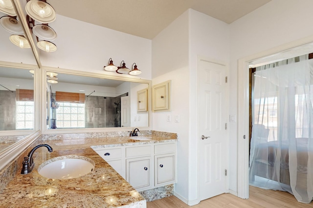 3404 Lockerbie Dr SE, Rio Rancho, NM 87124 - bathroom with wood finished floors, a sink, a shower stall, and double vanity