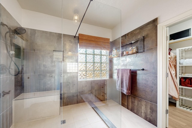 3404 Lockerbie Dr SE, Rio Rancho, NM 87124 - bathroom featuring walk in shower, wood finished floors, and a walk in closet
