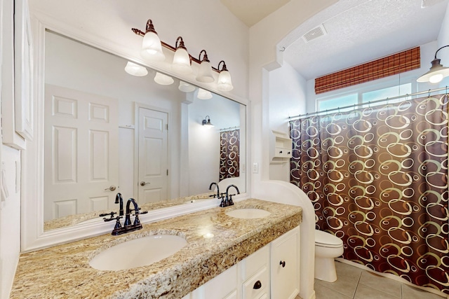 3404 Lockerbie Dr SE, Rio Rancho, NM 87124 - full bathroom featuring toilet, tile patterned floors, a sink, and visible vents