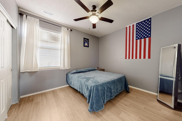 3404 Lockerbie Dr SE, Rio Rancho, NM 87124 - bedroom featuring ceiling fan, baseboards, and wood finished floors