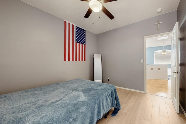 3404 Lockerbie Dr SE, Rio Rancho, NM 87124 - bedroom with ceiling fan, baseboards, and light wood-style floors