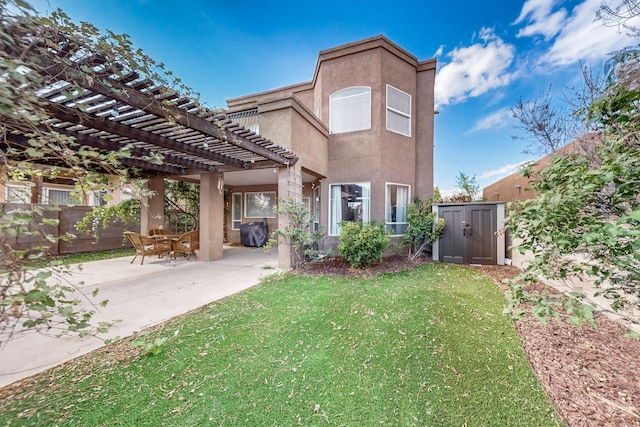 3404 Lockerbie Dr SE, Rio Rancho, NM 87124 - rear view of property featuring a pergola, a lawn, fence, a patio, and stucco siding
