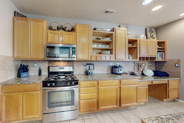 3404 Lockerbie Dr SE, Rio Rancho, NM 87124 - kitchen featuring open shelves, stainless steel appliances, visible vents, and light stone countertops