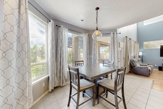 3404 Lockerbie Dr SE, Rio Rancho, NM 87124 - dining room featuring baseboards, light tile patterned flooring, a textured ceiling, and visible vents