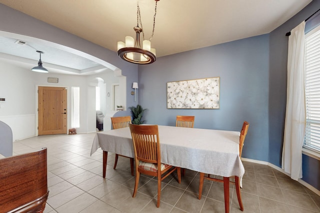 3404 Lockerbie Dr SE, Rio Rancho, NM 87124 - dining space featuring tile patterned floors, a chandelier, arched walkways, baseboards, and visible vents