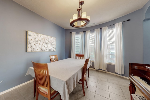 3404 Lockerbie Dr SE, Rio Rancho, NM 87124 - dining room featuring baseboards, a notable chandelier, visible vents, and light tile patterned floors